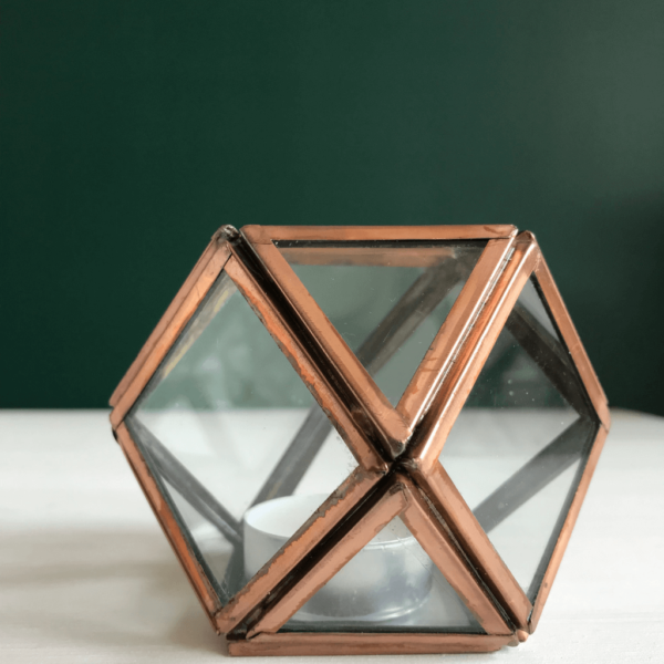 Geometric glass tea light holder. Each panel of glass framed with metal in a copper effect finish