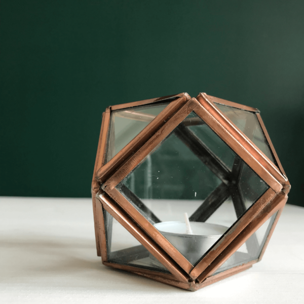 Geometric glass tea light holder. Each panel of glass framed with metal in a copper effect finish