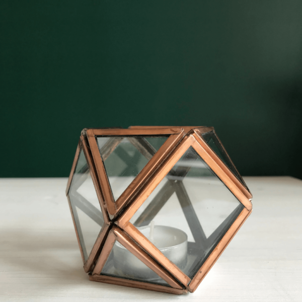 Geometric glass tea light holder. Each panel of glass framed with metal in a copper effect finish