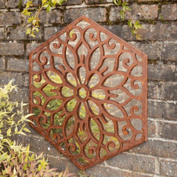 Hexagonal mirror with rusted cut out metal work