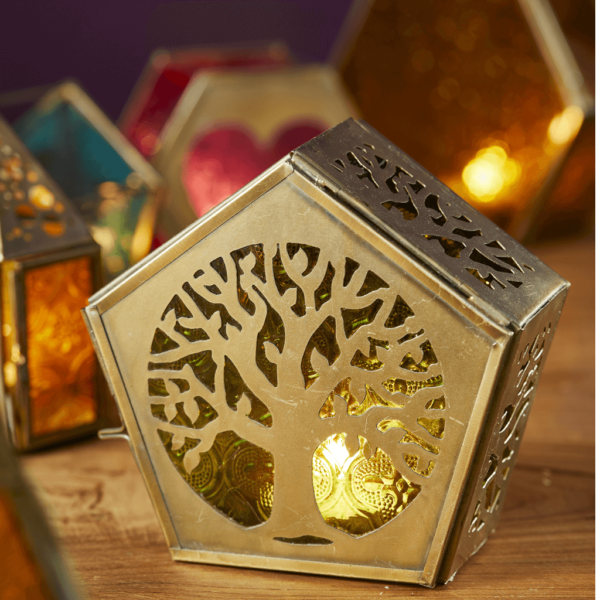 A pentagon shaped metalwork and green glass standing tealight lantern.